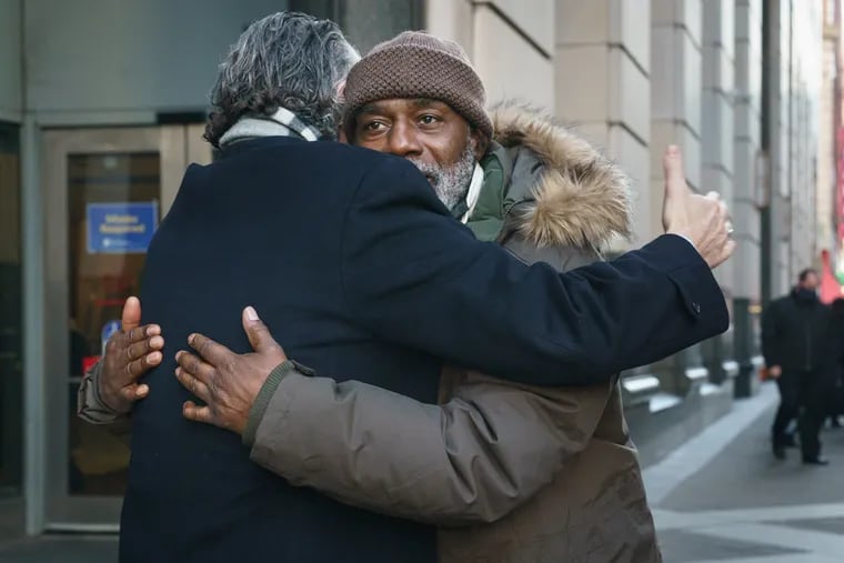 Willie Stokes embraces his lawyer, Michael Diamondstein, Thursday outside the Stout Center for Criminal Justice, after the Philadelphia District Attorney's Office agreed to drop the 37-year-old murder case against him.