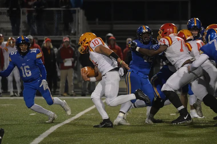 Trey Blair of Haverford High (No. 10 in white) running for yardage as Julian Williams of Downingtown West (No. 16 in blue) moves in during a District 1, Class 6A semifinal football game Nov. 15, 2019. The Central League, which includes Haverford, announced Friday it was postponing fall sports because of the coronavirus outbreak.