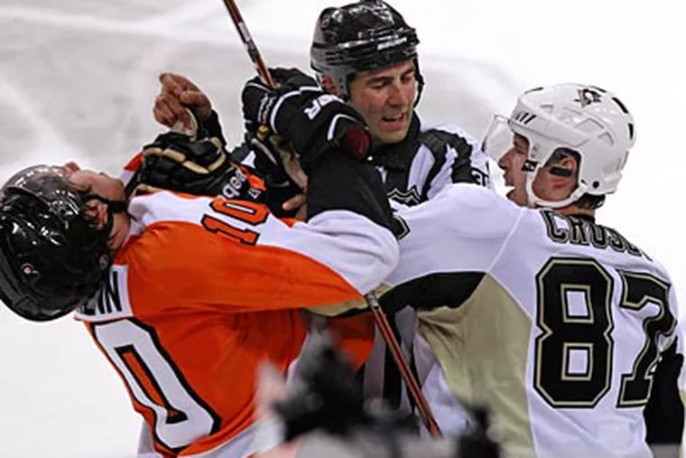 Penguins forward Sidney Crosby takes a swing at Flyers rookie Brayden Schenn in Game 3. (Ron Cortes/Staff Photographer)