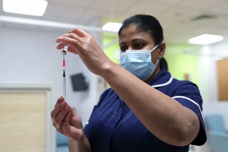 A nurse at the Royal Free Hospital, simulates the administration of the Pfizer vaccine to support staff training ahead of the rollout, in London, Dec. 4, 2020.  The United Kingdom has already approved use of the vaccine and expects to begin administering doses Dec. 8.  It will start by vaccinating people aged 80 above, some nursing homes staff and other high-risk health workers.