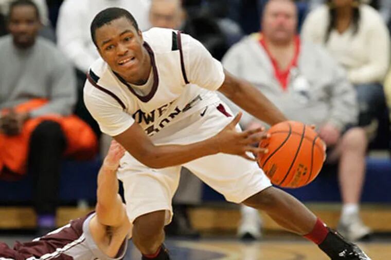 Lower Merion's JaQuan Johnson is fouled by Prep's PJ Kelly after a steal. (Ron Cortes / Staff Photographer)