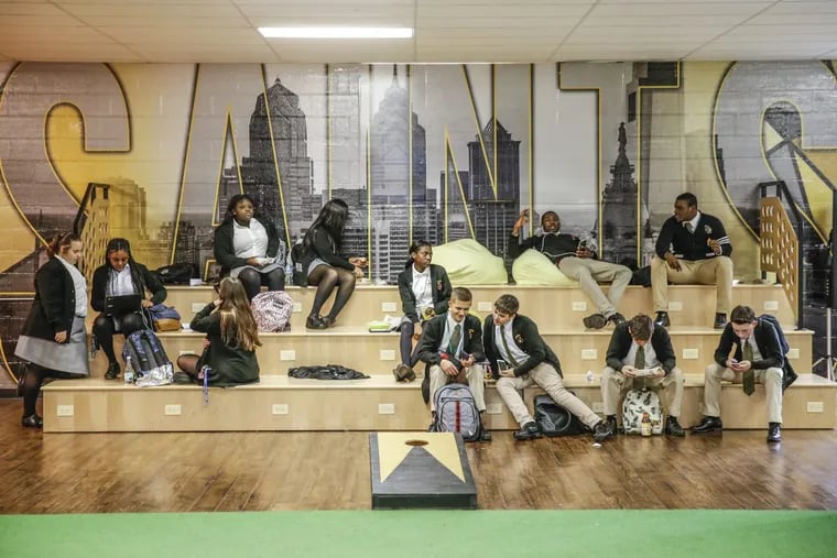 Neuman-Goretti High School students hang out on the bleacher seats in the cafeteria. Its recent renovation borrowed design ideas from millennial office culture.