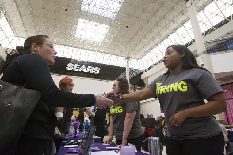Anisha Turner, right, recruiter for the Protocol Group Company, talks to Michelle Cassidy of Levittown, during the Recruitment Queen Job Fair inside the Sears court at Oxford Valley Mall in Langhorne, Pa. Wednesday, January 17, 2018.