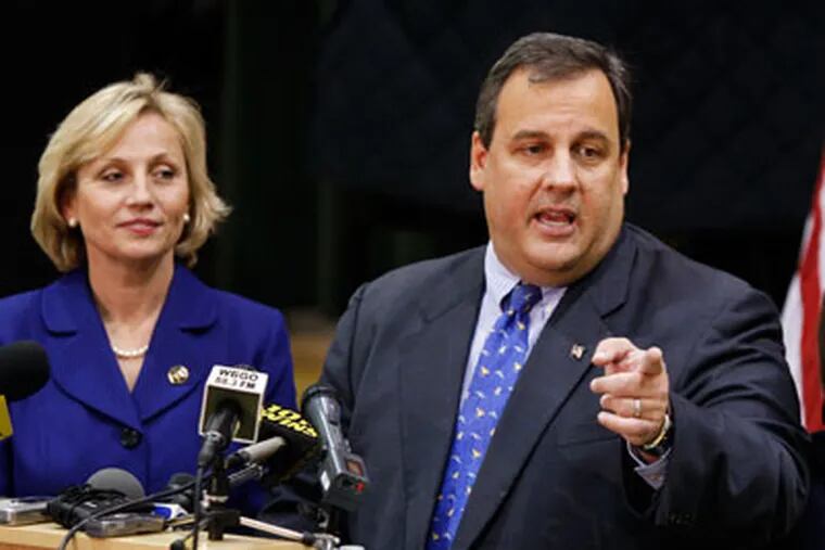 Governor elect Chris Christie answers a question as he stands with Lt. governor elect Kim Guadagno in Newark, N.J. (AP Photo/Mel Evans)