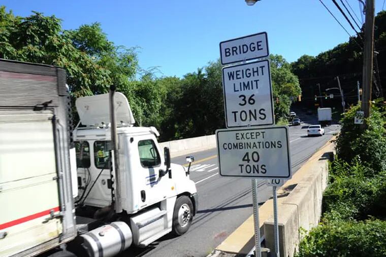 The Baltimore Avenue Bridge over Darby Creek, on the border of Lansdowne and Clifton Heights Boroughs, has a new weight restriction posted for heavy trucks.  Due to the transportation budget impasse, PennDOT says about 130 bridges in suburban Philadelphia will now have weight restrictions posted, which will means miles-long detours for trucks.  ( CLEM MURRAY / Staff Photographer )