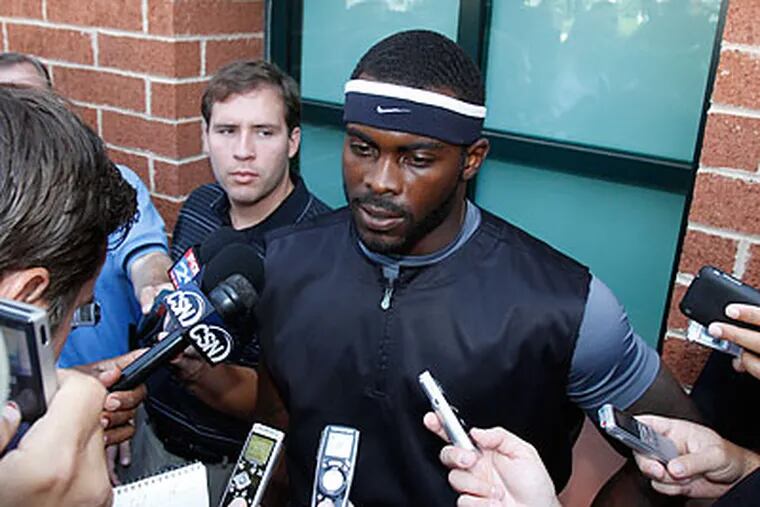 Michael Vick was at the center of attention as players arrived at the NovaCare Center yesterday. (Charles Fox/Staff Photographer)