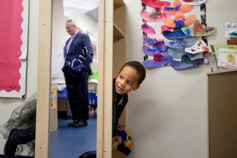 Carter Webb peeks out of a cubby to see Mayor Jim Kenney at Your Child's World Learning Center in Southwest Philadelphia in January. Today marks the two-year anniversary of Mayor Kenney's universal Pre-K initiative, which also funded slots at the school where Meyata McMichael teaches.