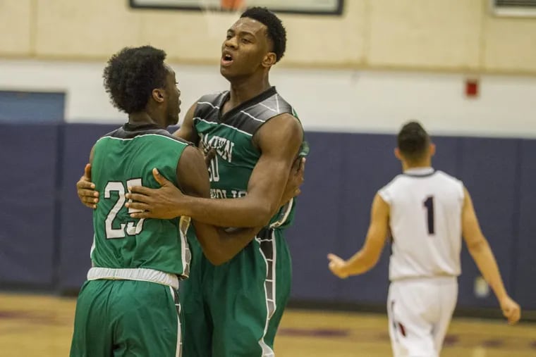 Uche Okafor (right) and Baba Ajike (left, both shown in a game last season) combined for 55 points in Camden Catholic's 7-54 win over Camden on Friday.