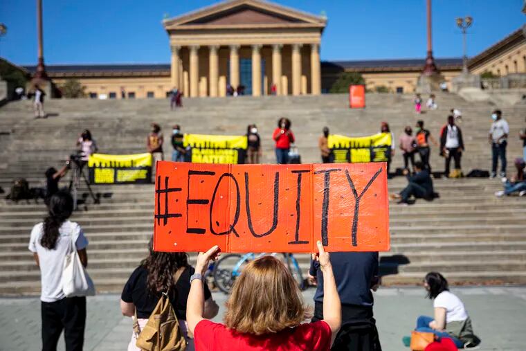 Debra Oconnor, of Fairmount, Philadelphia, holds a sign reading “#Equity” during a rally in honor for Breonna Taylor and in solidarity with Louisville, Ky., at the Philadelphia Art Museum steps in Philadelphia, Pa., on Saturday, Oct. 4, 2020. “I support Black Lives Matter and opposed to racial injustice,” Oconnor said.