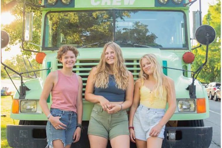 From left, Bekah King, 18, Abi Roberts, 19, and Morgan Tabor, 21, in front of the bus they converted and took on a months-long road trip after they found out they were all dating the same man.
