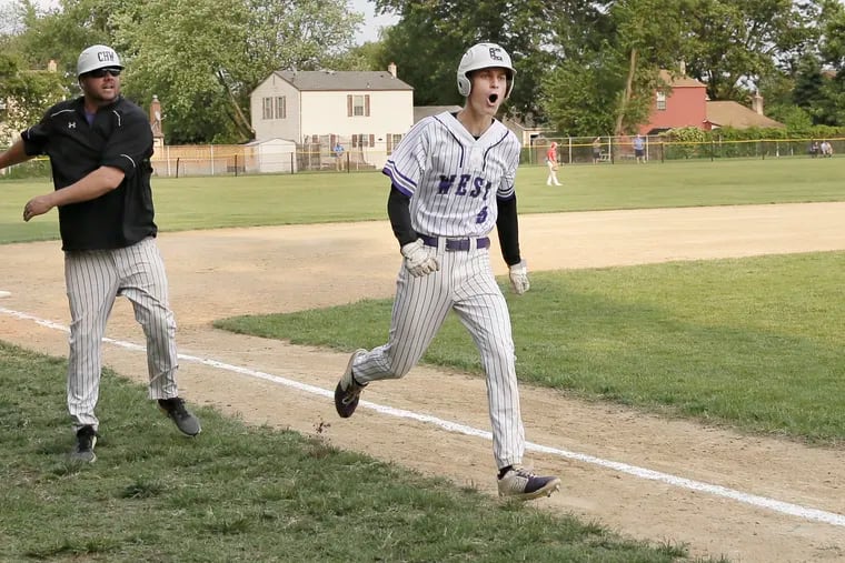 Cherry Hill West’s Scott Shaw rounds third base after hitting a two run home run in the top of the 7th inning of the Lions' 6-3 win over Triton in the South Jersey Group 3 title game, Cherry Hill West coach Dan McMaster (left) celebrates the hit that turned a 3-2 deficit into a 4-3 lead.