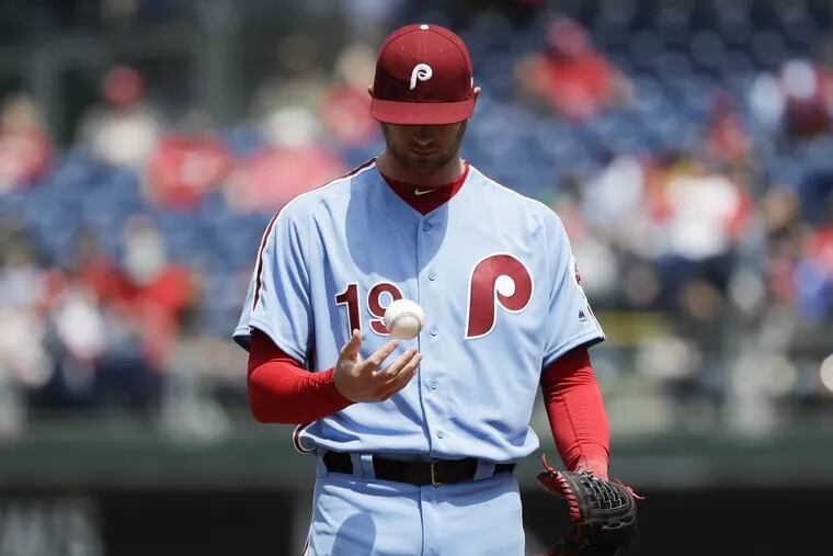 Phillies pitcher Ben Lively tosses the baseball after giving up three runs in the first inning against the Diamondbacks.