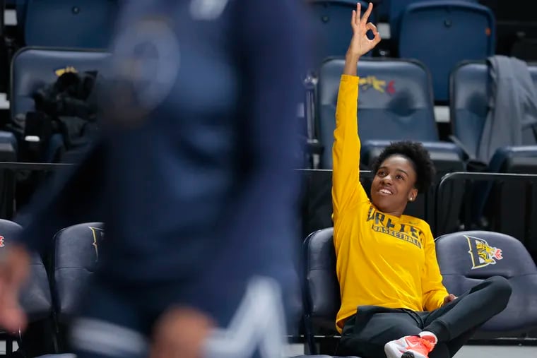 Drexel great Keishana Washington reacts to a three-pointer in practice on Tuesday. Washington flew in from Canada to show her support for the team and has been with them since the start of the CAA Tournament.