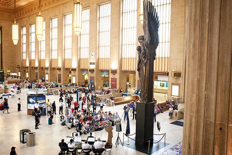 A small gathering of participants gathers in front of the famous statue at Amtrak's 30th street station. (File / Ed Hille / Staff Photographer)
