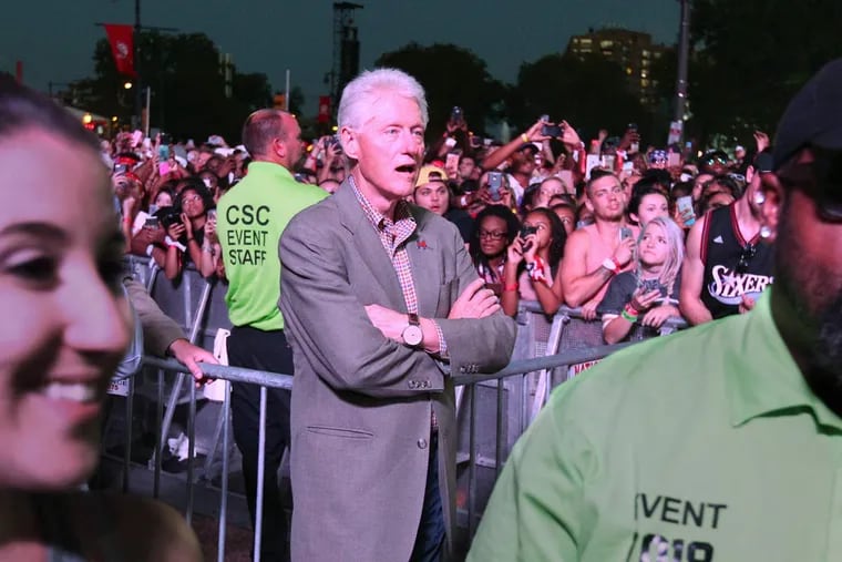 Former President Bill Clinton watches Chance the Rapper on the Rocky Stage Sunday night at Made in America.