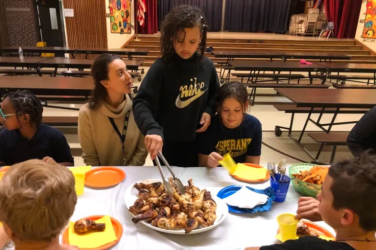 Bayard Taylor chef Gyliani Ortiz (center) was proud to serve golden brown chicken thighs to teacher Nicole Molino and her sister Syliani Ortiz. Ms. Molino organizes the Bayard Taylor cooking class and
Syliani was a chef in it last year.
