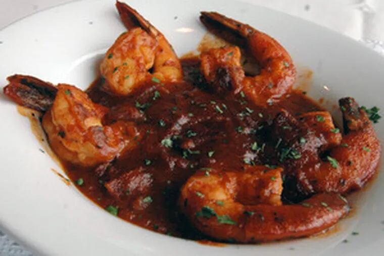 Cajun Louisiana barbecue shrimp and bacon , five large shrimp sauteed in a spicy barbecue sauce with bits of bacon.