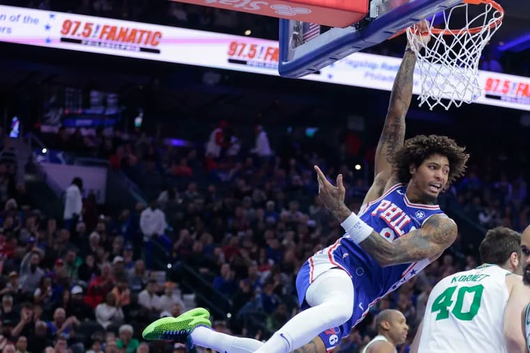 Kelly Oubre, Jr. of the Sixers dunks against the Celtics during the first half of their game at the Wells Fargo Center on Nov. 8, 2023. He was called for a echnical foul for hanging on the rim.