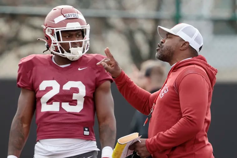 Temple running back Edward Saydee gets instructions from head coach Stan Drayton during the Owls' annual Cherry and White football game at Temple’s Edberg-Olson Field on April 8, 2023.