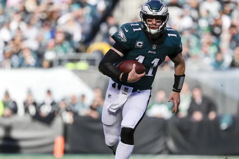 Eagles quarterback Carson Wentz runs with the football during third-quarter against the Chicago Bears on Sunday.