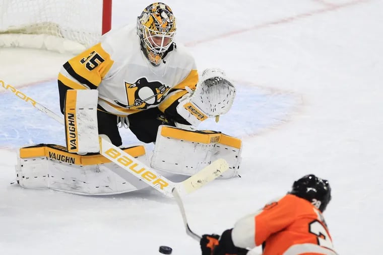 A shot by the Flyers’ Claude Giroux gets turned aside by Tristan Jarry of the Penguins during the first period at the Wells Fargo Center on Jan. 2.