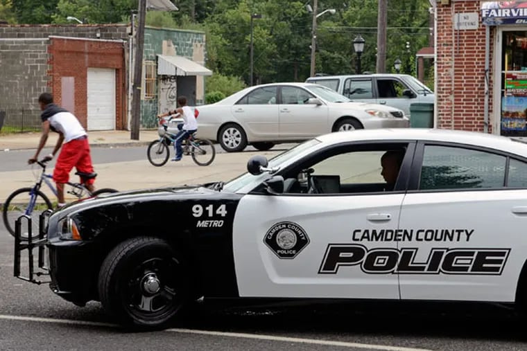 A Camden County police officer makes a car stop while he patrols the Fairview neighborhood in this file photograph.