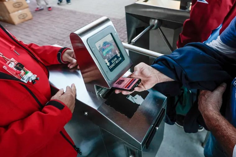 Phillies fans scan e-tickets as they get ready for game 3 of the NLCS at Citizens Bank Park in Philadelphia, Friday,  October 21, 2022