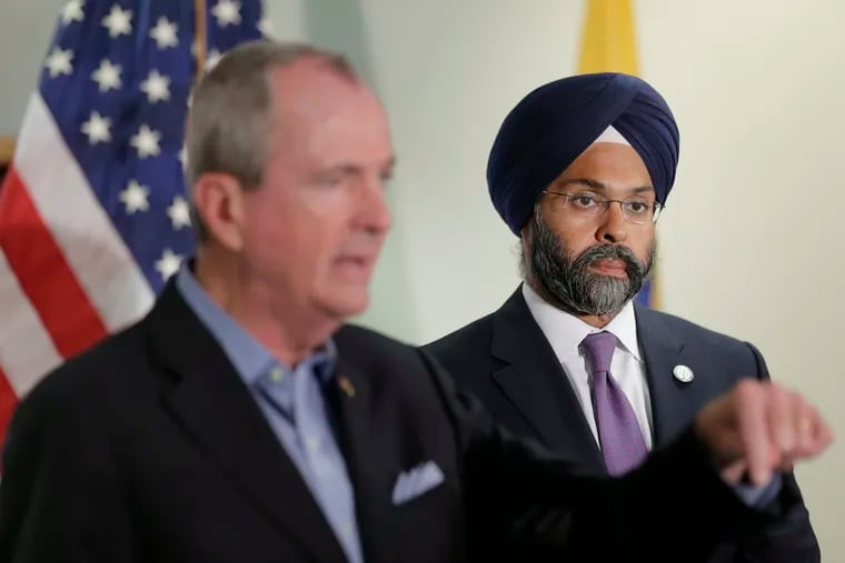 While New Jersey Gov. Phil Murphy, left, speaks, Attorney General Gurbir Grewal looks on after a bill signing ceremony last week in Berkeley Heights.