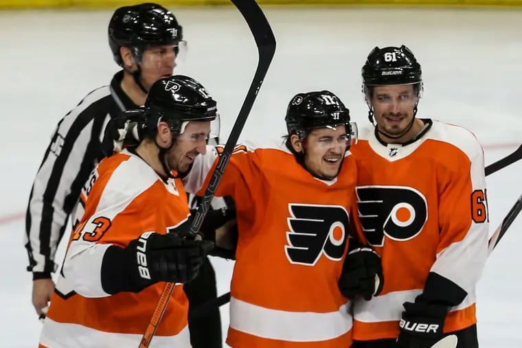 Flyers' Travis Konecny center celebrates after his goal against the Blue Jackets with teammates Kevin Hayes, left and Justin Bruan during the third period at the Wells Fargo Center in Philadelphia, Tuesday,  February 18, 2020.  Flyers beat the   Blue Jackets 5-1.