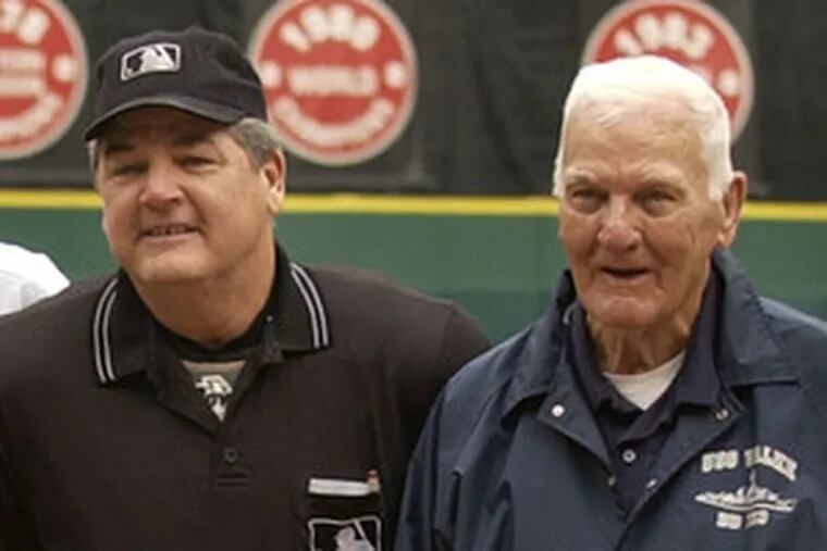 Jerry Crawford stands next to his father before umpiring the final game at the Vet. Shag Crawford worked the first.