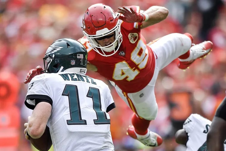 Chiefs safety Daniel Sorenson leaps to bring down Eagles quarterback Carson Wentz.