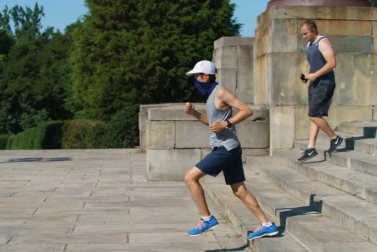 Jeffrey Liu running the steps of the Philadelphia Art Museum, while wearing a mask, on July 2.