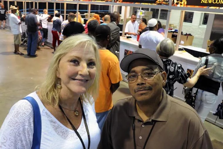 Anthony Edmondson (right), ex. dir. of Narcotics Anonymous World Services (NAWS), and Rebecca Meyer, asst. ex. dir of NAWS in the registration area of the PA Convention Center prior to the start of their national convention Aug. 28, 2013.   ( CLEM MURRAY / Staff Photographer )