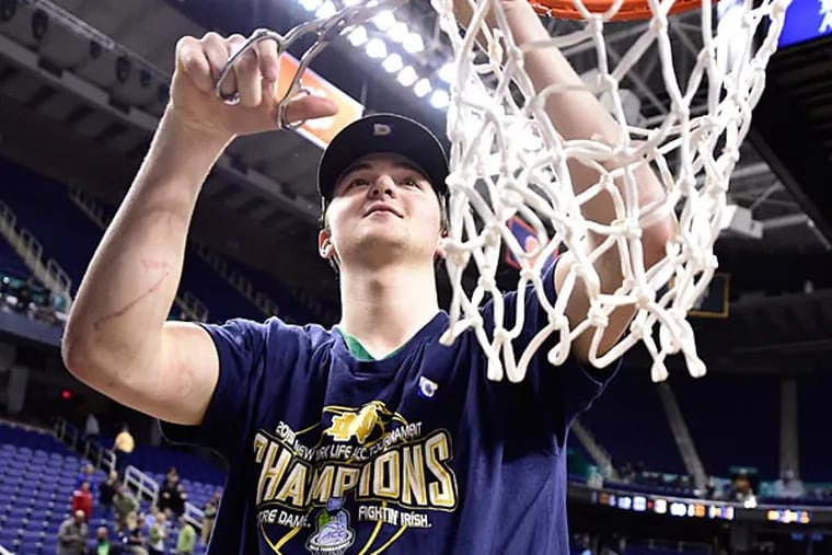 Notre Dame Fighting Irish guard Steve Vasturia (32) helps cut down the net. The Fighting Irish defeated the North Carolina Tar Heels 90-82 in the championship game of the ACC Tournament at Greensboro Coliseum. (Bob Donnan/USA Today)