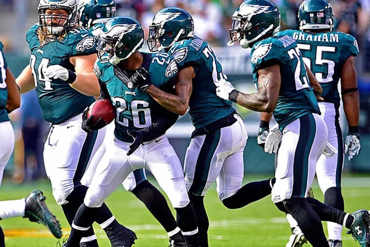 Philadelphia Eagles strong safety Walter Thurmond (26) is congratulated by his teammates after intercepting the ball during the fourth quarter against the New York Jets at MetLife Stadium. The Philadelphia Eagles defeated the New York Jets 24-17.