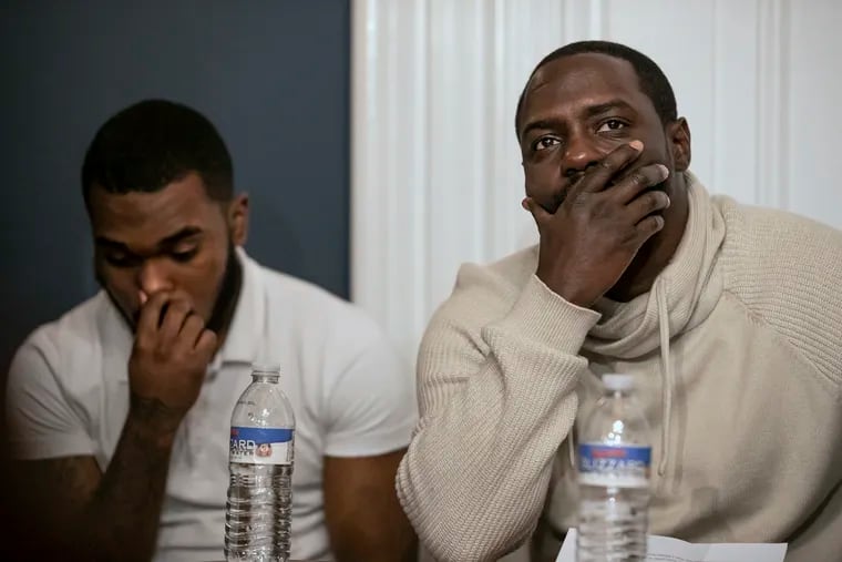 Tawfeeq Abdul-Lateef, left, and Laboy Wiggins, both alleged victims of abuse at the Glen Mills Schools, listen during a news conference at the Eisenberg Rothweiler Winkler Eisenberg & Jeck law office in Center City. The attorneys filed five new lawsuits against the school.