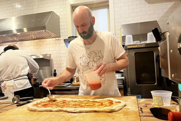 Marc Vetri, his beard dyed green in the Eagles spirit, makes a test pizza for Pizzeria Salvy upstairs at Vetri Cucina.