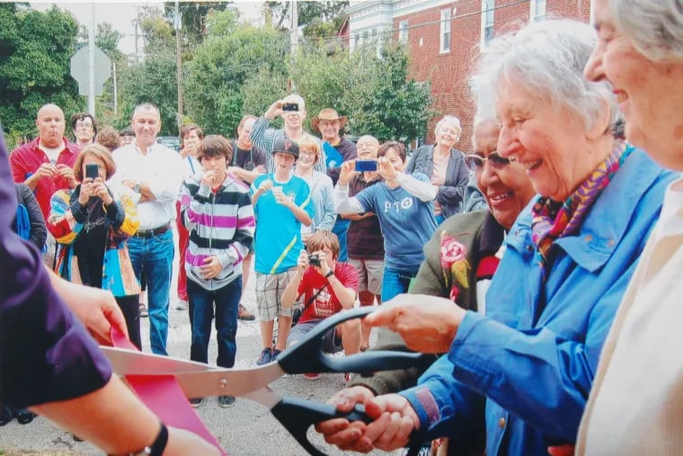 Mrs. Schatz (second from the right) cuts the ribbon in October 2012 at the reopening of Weavers Way Co-op following renovations to the Mount Airy store.