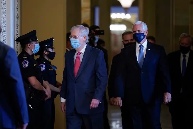 Senate Majority Leader Mitch McConnell, R-Ky., left, and Vice President Mike Pence, right, walking through a hallway in the Capitol on Sept. 29.