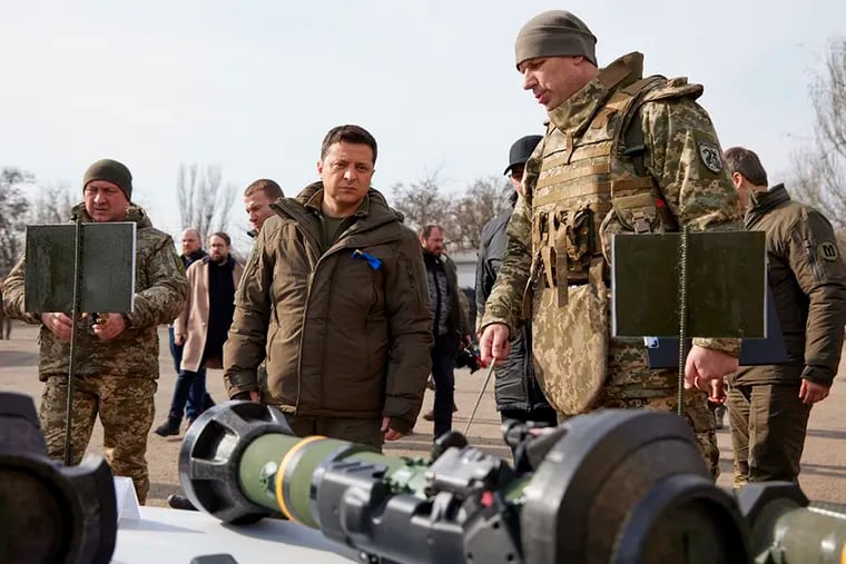 Ukrainian President Volodymyr Zelenskyy (center) inspects weapons during a visit to Ukrainian coast guards in Mariupol in eastern Ukraine on Feb. 17, 2022.