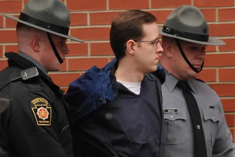 Eric Frein, center, is escorted into the Pike County Courthouse by Pennsylvania State troopers for a preliminary hearing on murder and terrorism charges Monday, Jan. 5, 2015 in Milford, Pa. BRADLEY C. BOWER / For the Inquirer
