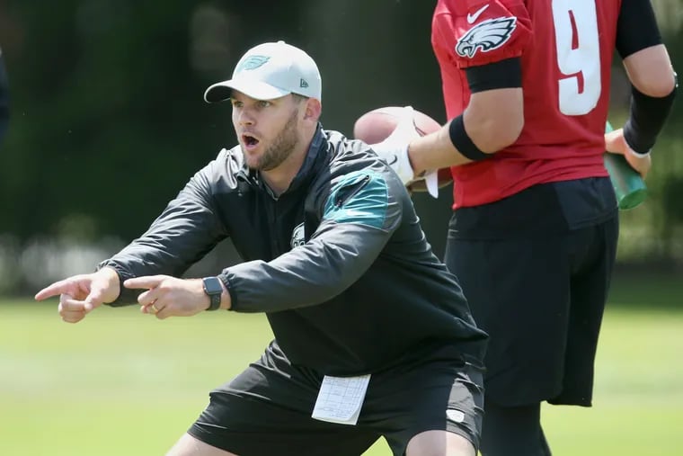 Eagles quarterbacks coach Press Taylor leads a drill during the team's final day of organized team activities at the NovaCare Complex in South Philadelphia on Thursday, June 7, 2018. TIM TAI / Staff Photographer