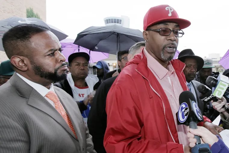 Councilman Curtis Jones, left, listens to Prospect cabin cleaner Anthony Reynolds speak during a rally of workers at the Philadelphia International Airport on Oct. 22, 2014. (ELIZABETH ROBERTSON/Staff Photographer)