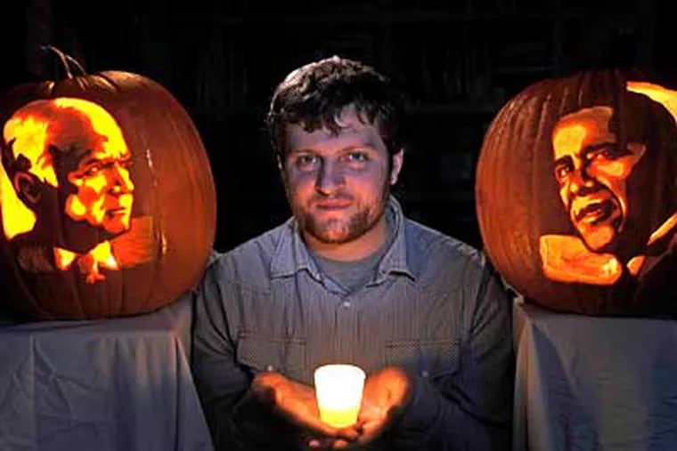 Nate Johnson poses with his pumpkin portraits of the two presidential canidates, John McCain (left) and Barack Obama (right). (Clem Murray/Staff Photographer)