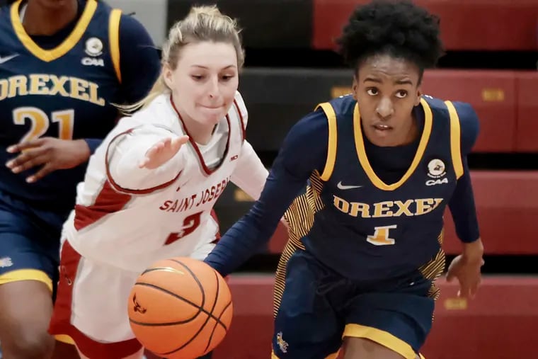 Emma Boslet of St. Joseph's tries to tip the ball from Drexel’s Keishana Washington during a game earlier this season.