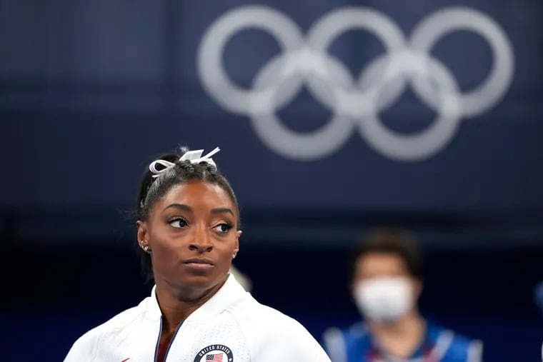 Simone Biles, of the United States, watches gymnasts perform after she exited the team final at the 2020 Summer Olympics, in Tokyo.