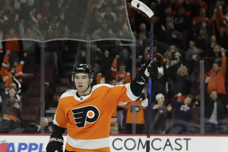 Flyers defenseman Ivan Provorov raises his stick after scoring a late third-period empty net goal against the New York Islanders on Thursday, January 4, 2018 in Philadelphia.