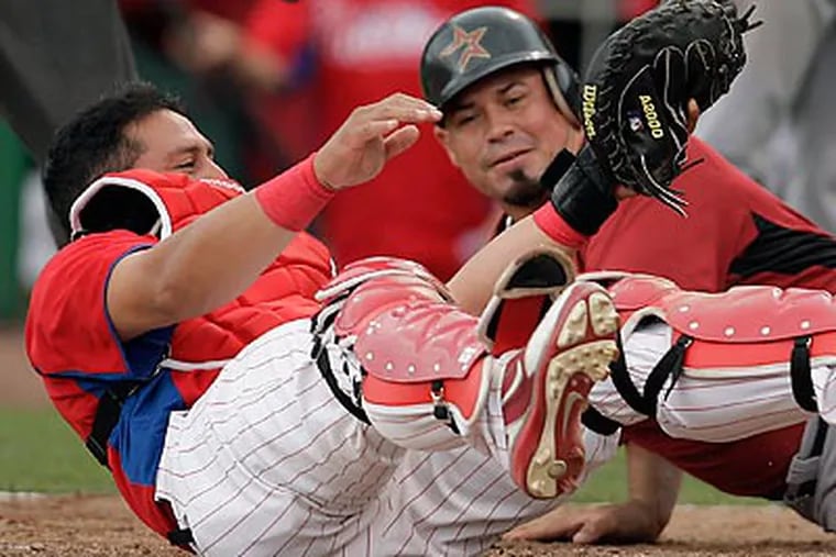 Carlos Ruiz hangs on to the ball after tagging out Houston's Humberto Quintero. (David Maialetti/Staff Photographer)