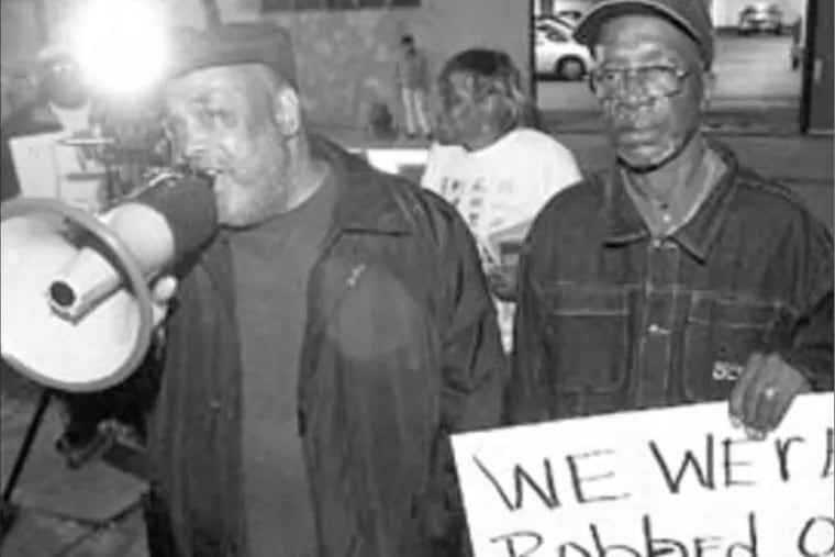 Leodus Jones (left) and Warren Summers, former inmates at Holmesburg Prison, in an Inquirer file photo from Oct. 29, 2003. They’re protesting an award given to Albert Kligman, a University of Pennsylvania dermatologist who developed Retin-A and who conducted experiments at Holmesburg.