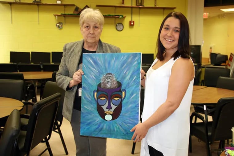 Sally Guariglia is turning digital photos of her art into a memory book with the help of Moore College sophomore Savannah Harvey. (MICHELE COHEN / MOORE COLLEGE OF ART & DESIGN)
